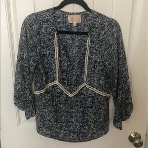 Blue and white patterned V neck blouse